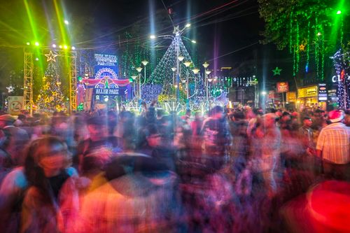 Free A lively crowd enjoys Christmas festivities under colorful lights in Kolkata's Allen Park. Stock Photo