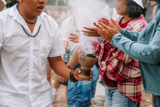 A cultural ritual in Valladolid, Yucatán with people engaging in a spiritual smudging ceremony.
