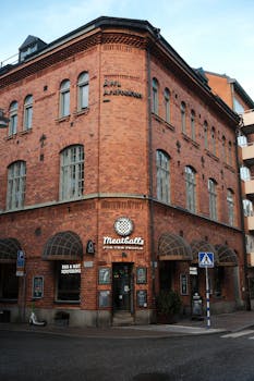 Charming red brick corner building housing a restaurant with vintage signage.