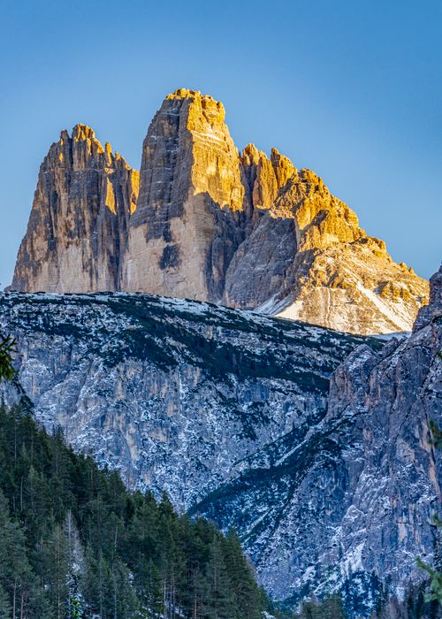 Free Spectacular view of snow-dusted Dolomites at sunrise with golden peaks. Stock Photo