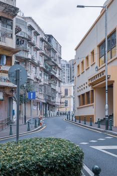 Explore a quaint street in Macau showcasing traditional and historic architecture on a quiet day.