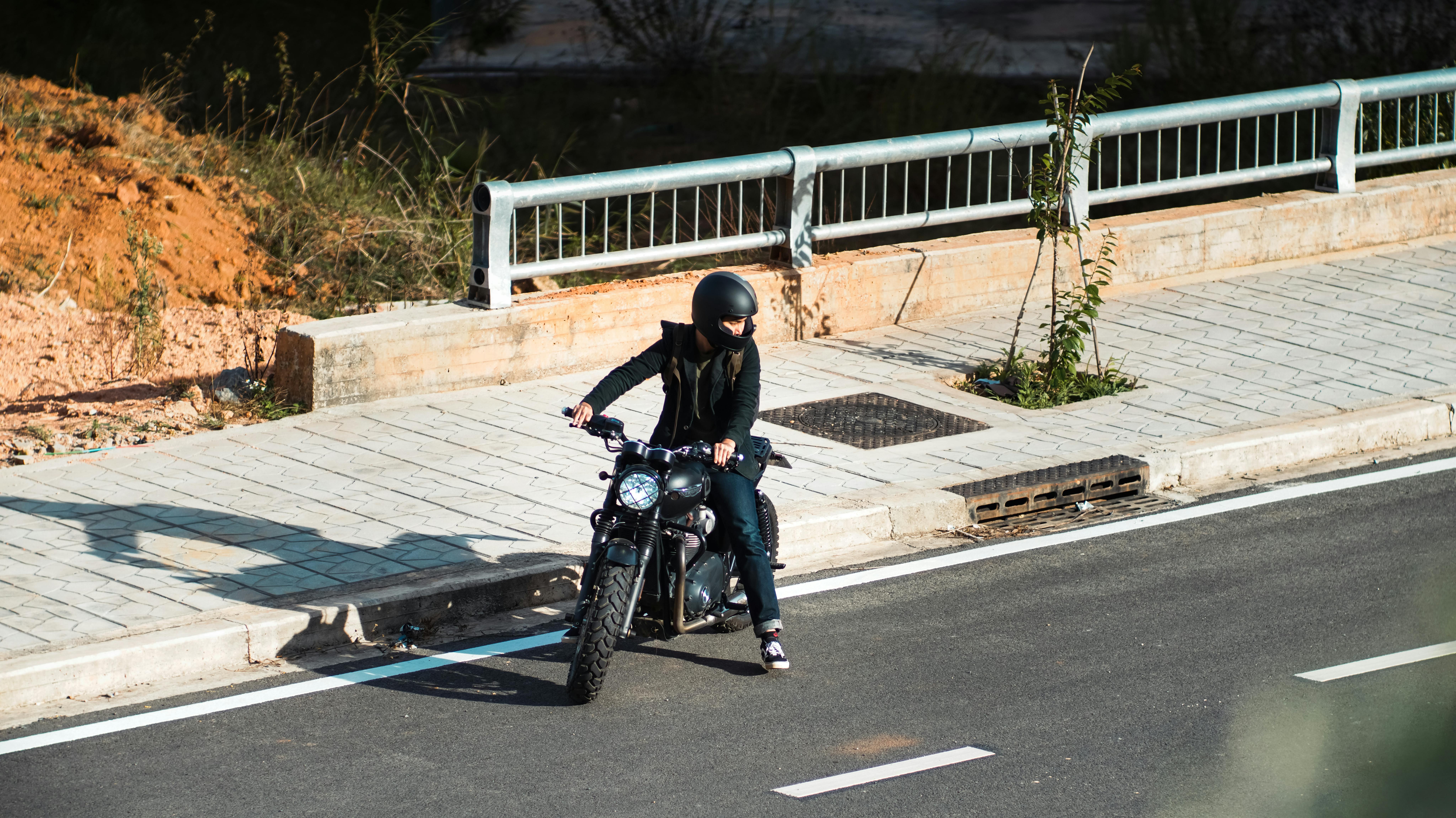 motorcyclist riding along empty city street