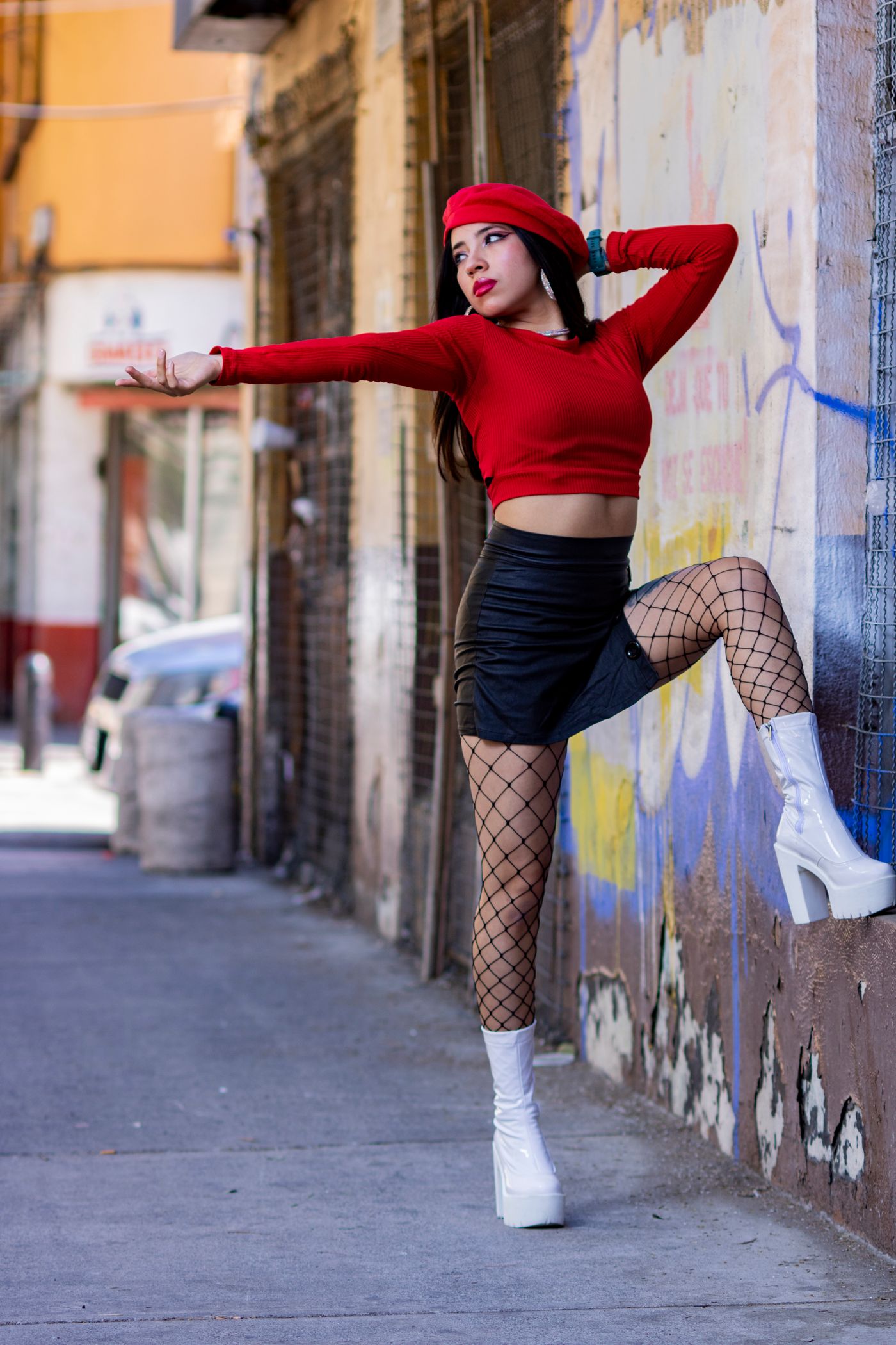 Urban fashion model in a bold red and black streetwear outfit