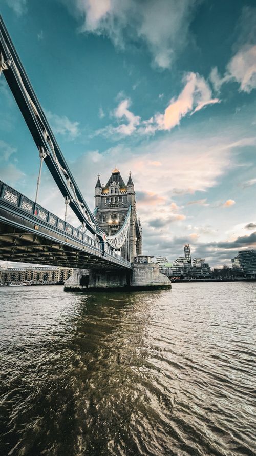 Free Iconic view of Tower Bridge spanning the River Thames in London with a scenic sky. Stock Photo