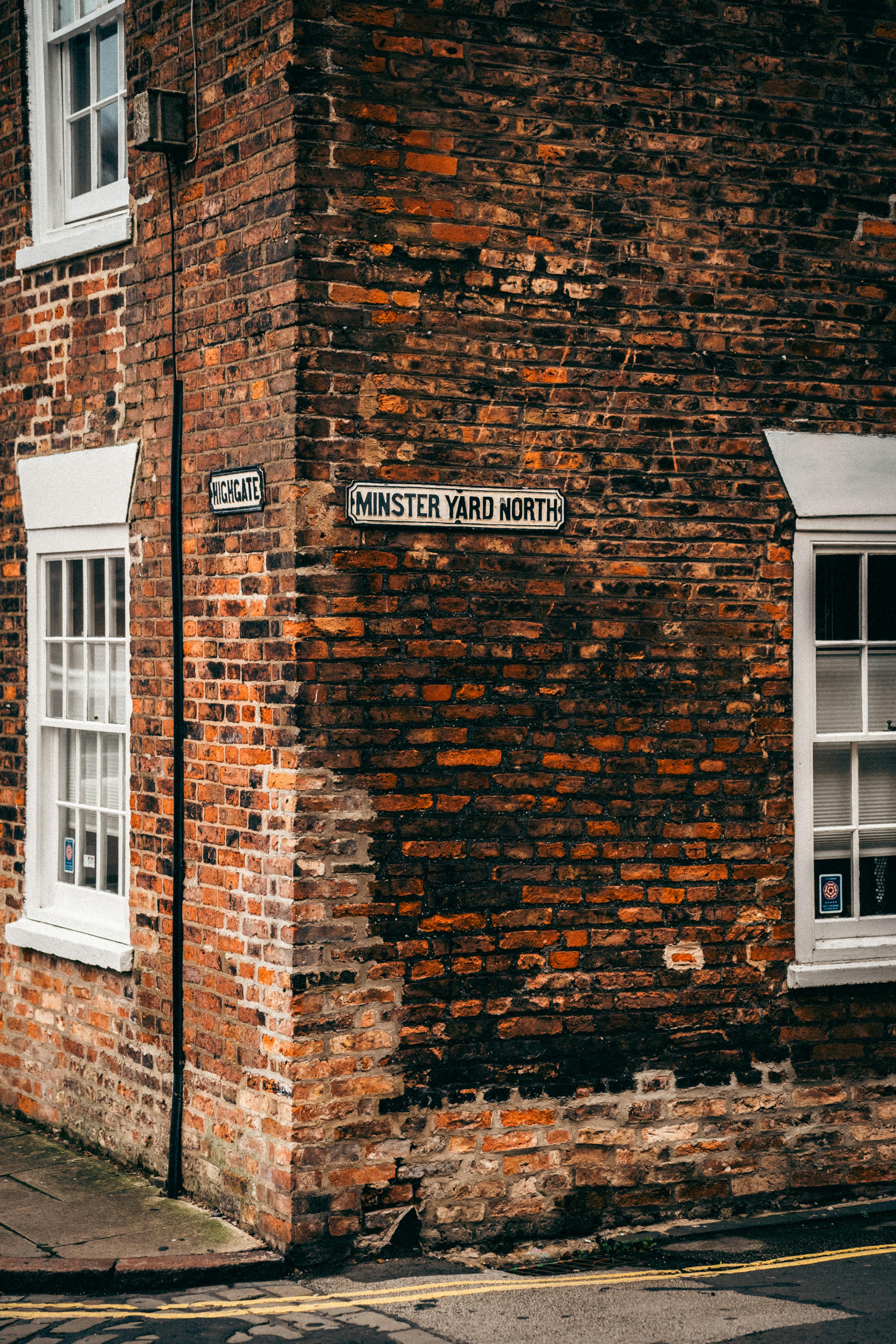 Free Classic urban architecture with vintage street signs. Brick building at Minster Yard North. Stock Photo