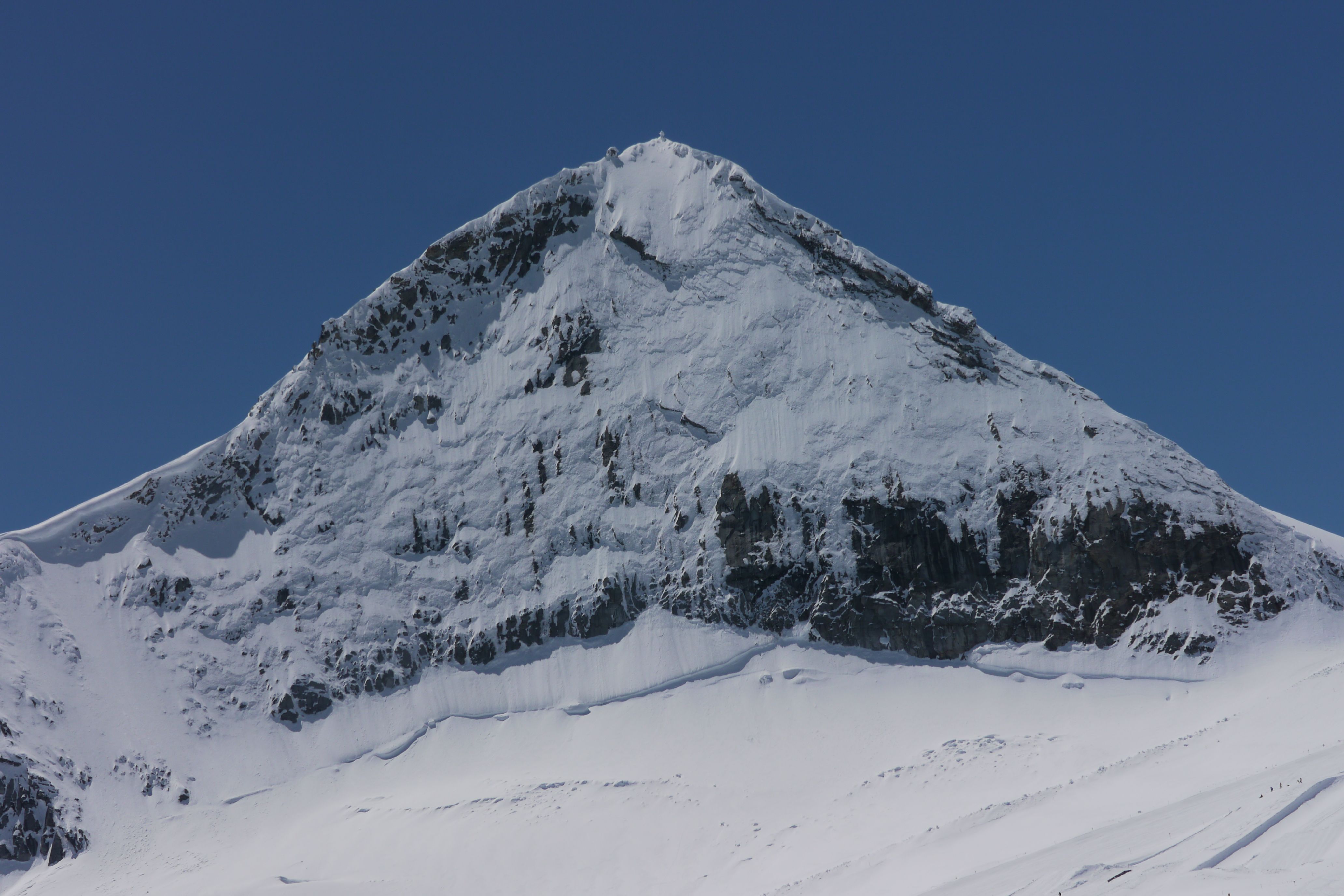 Majestic Snow-Covered Mountain Peak Under Clear Blue Sky · Free Stock Photo