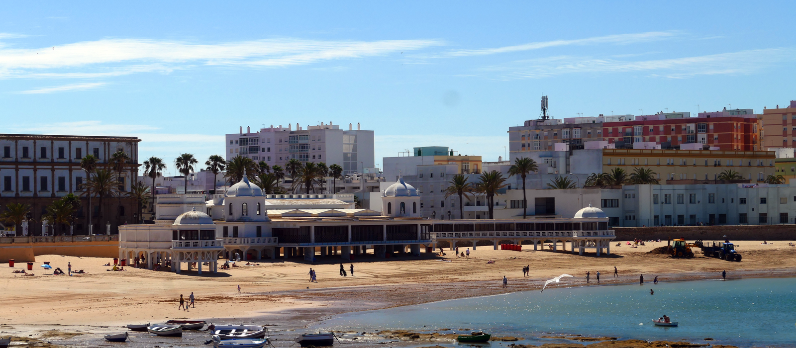 Scenic daytime view of La Caleta beach with historic bathhouse in Cádiz, Andalusia, Spain.