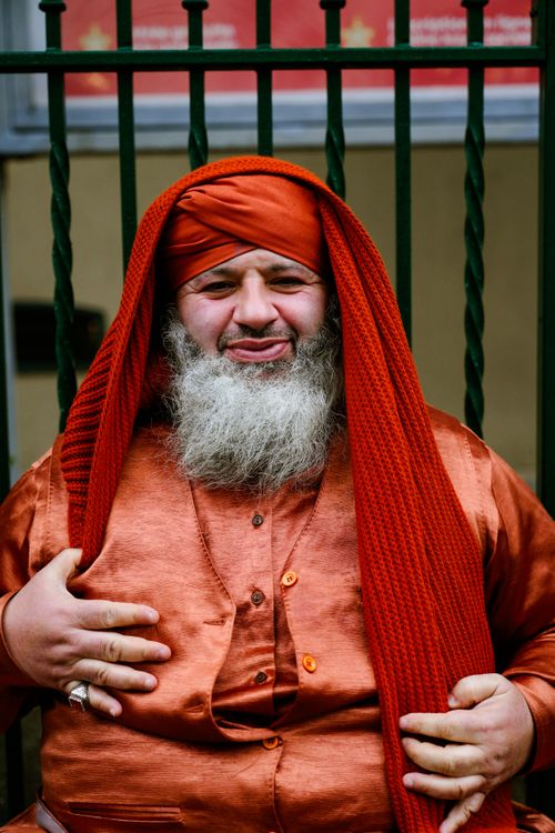 Free A bearded man wearing traditional attire poses confidently outdoors. Stock Photo