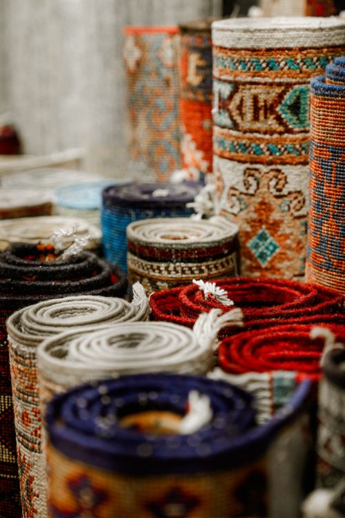 Free A variety of rolled colorful rugs showcasing intricate traditional patterns. Stock Photo