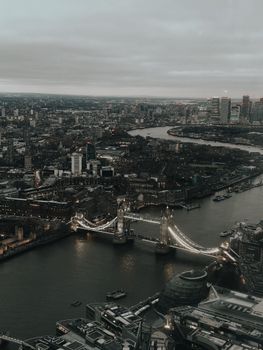 Stunning aerial view of London's iconic Tower Bridge over the River Thames with the city skyline at dusk.