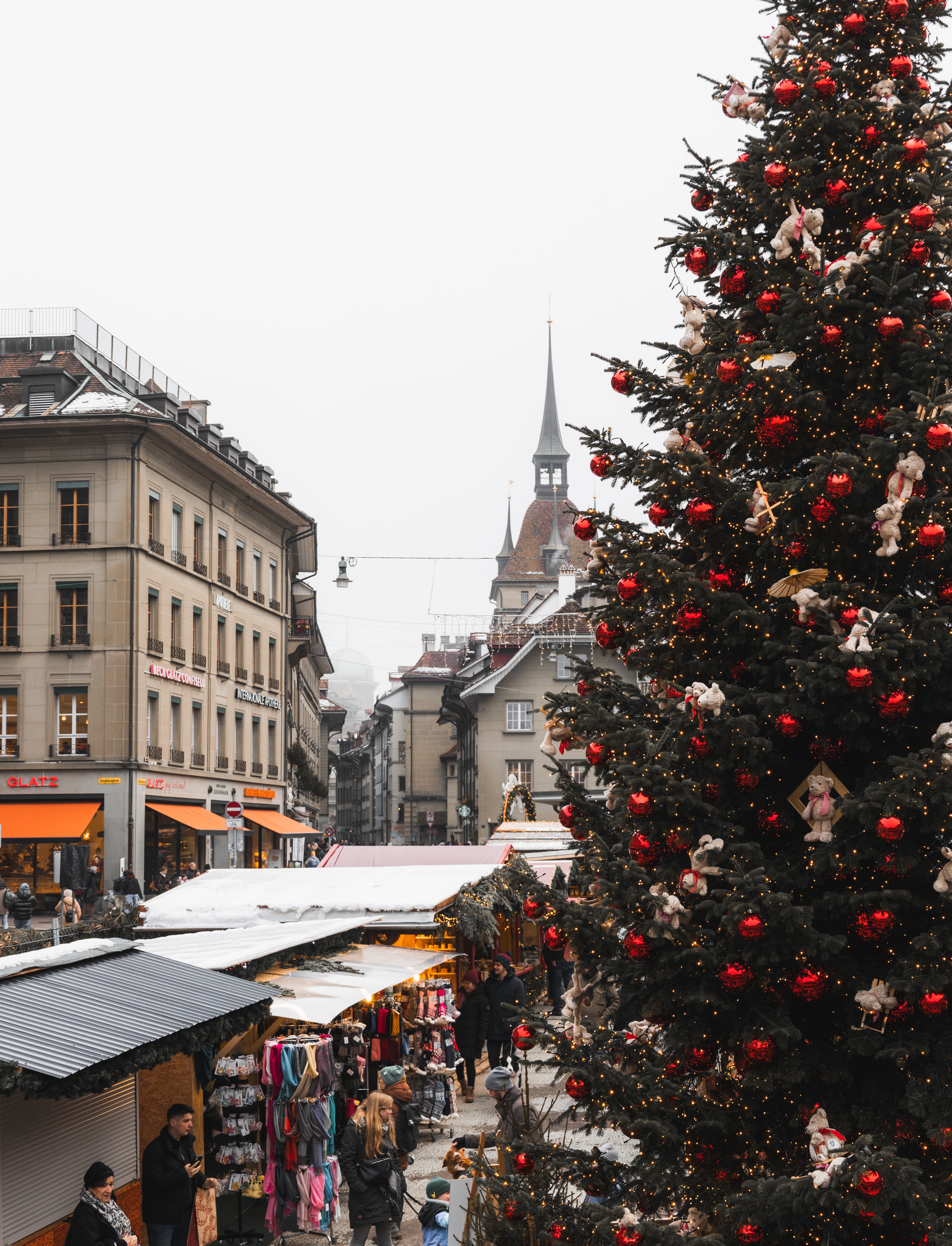 Festive Christmas Market in Snowy European Town · Free Stock Photo