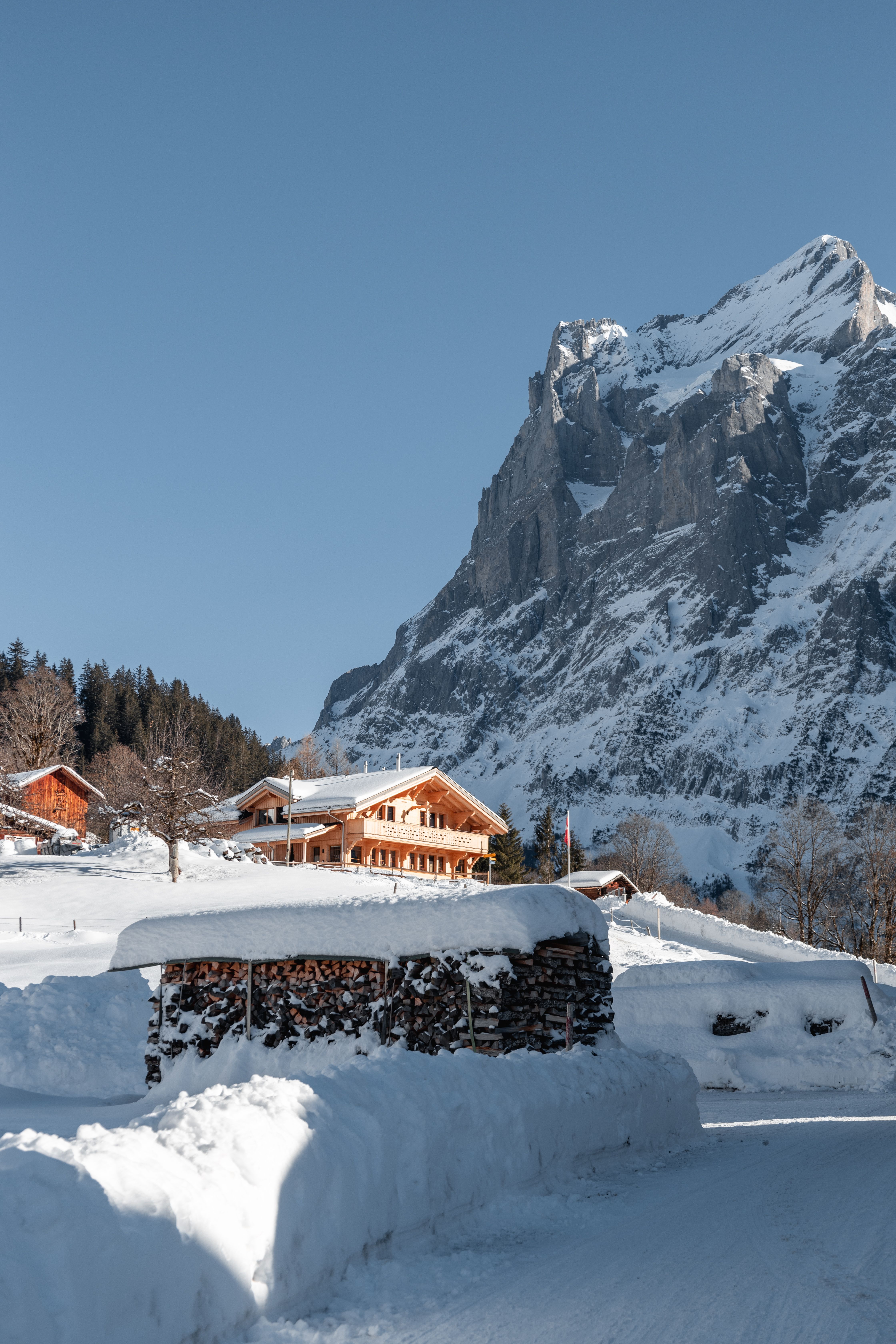 Picturesque Swiss Chalet in Snowy Alps Landscape · Free Stock Photo