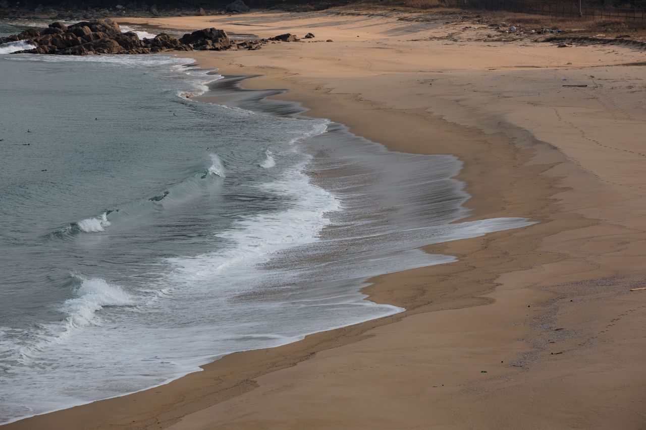 peaceful sandy beach with gentle waves ideal for relaxation and tranqu