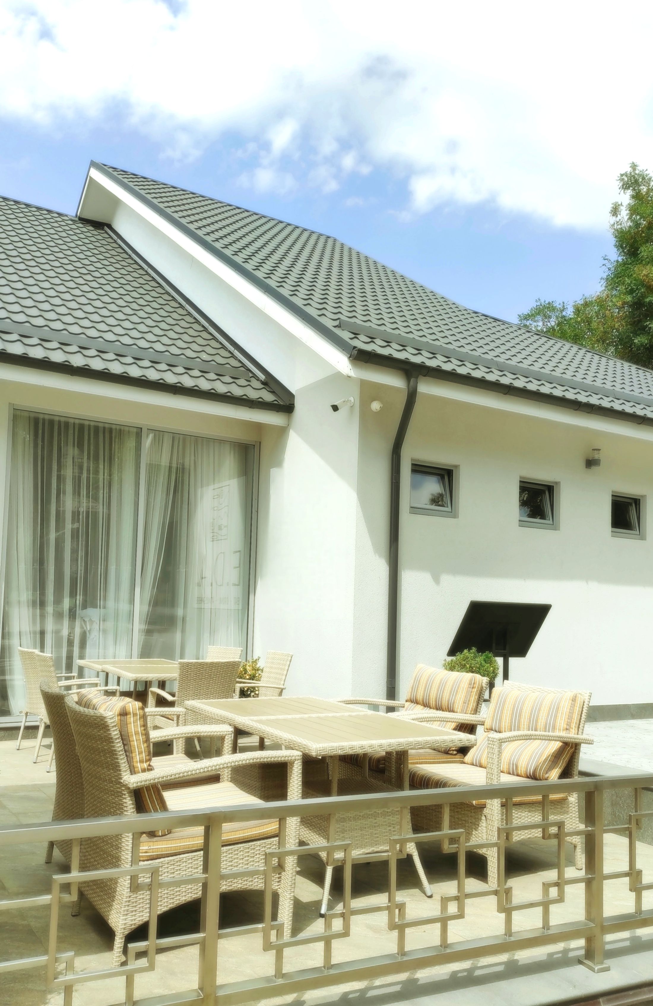 Stylish residential outdoor patio with modern furniture and wooden deck