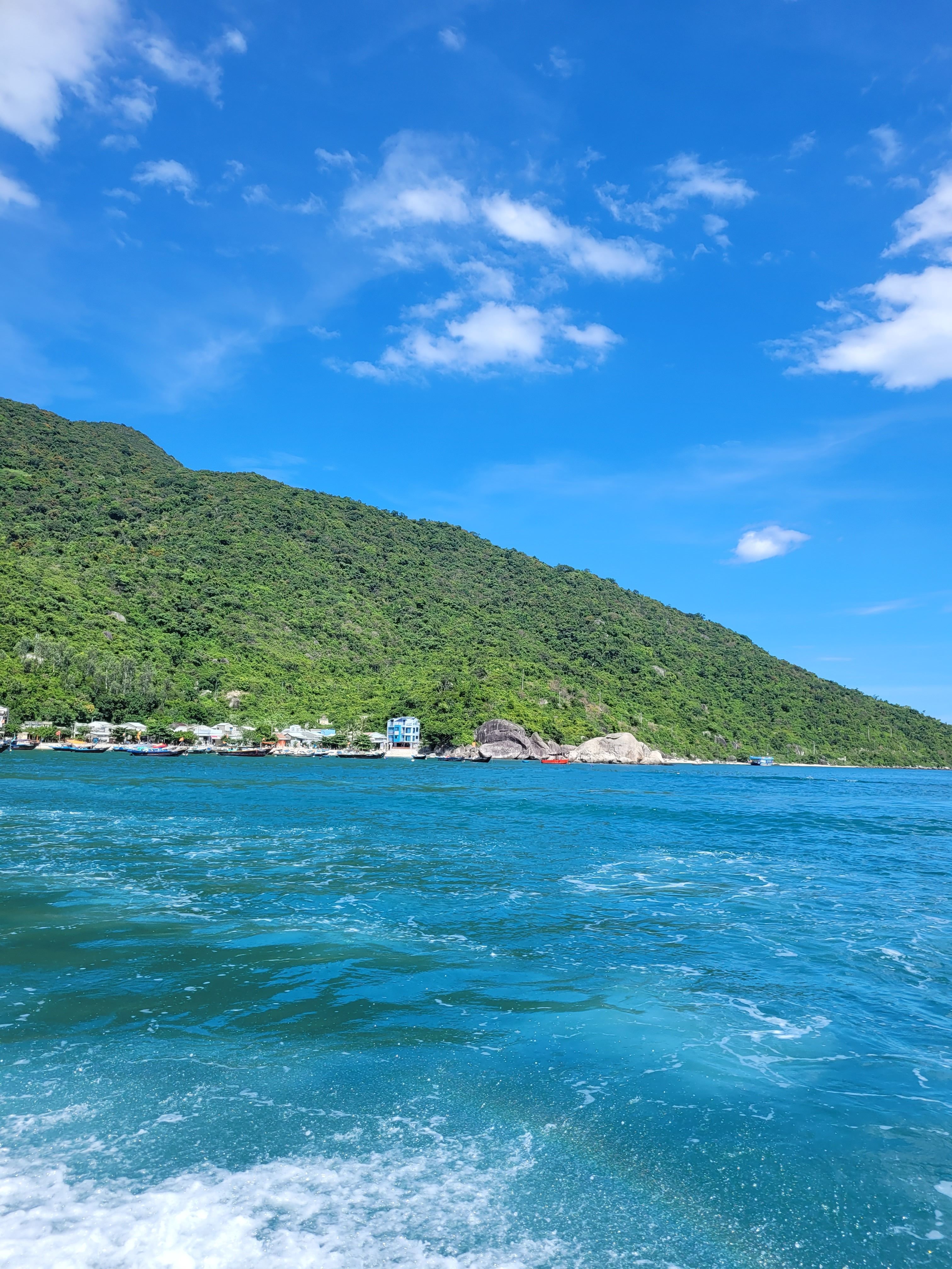 Scenic Coastal View with Lush Green Hills · Free Stock Photo