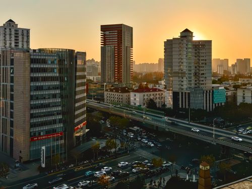 Free Vibrant sunset illuminating the high-rise skyline of Shanghai, showcasing city life. Stock Photo