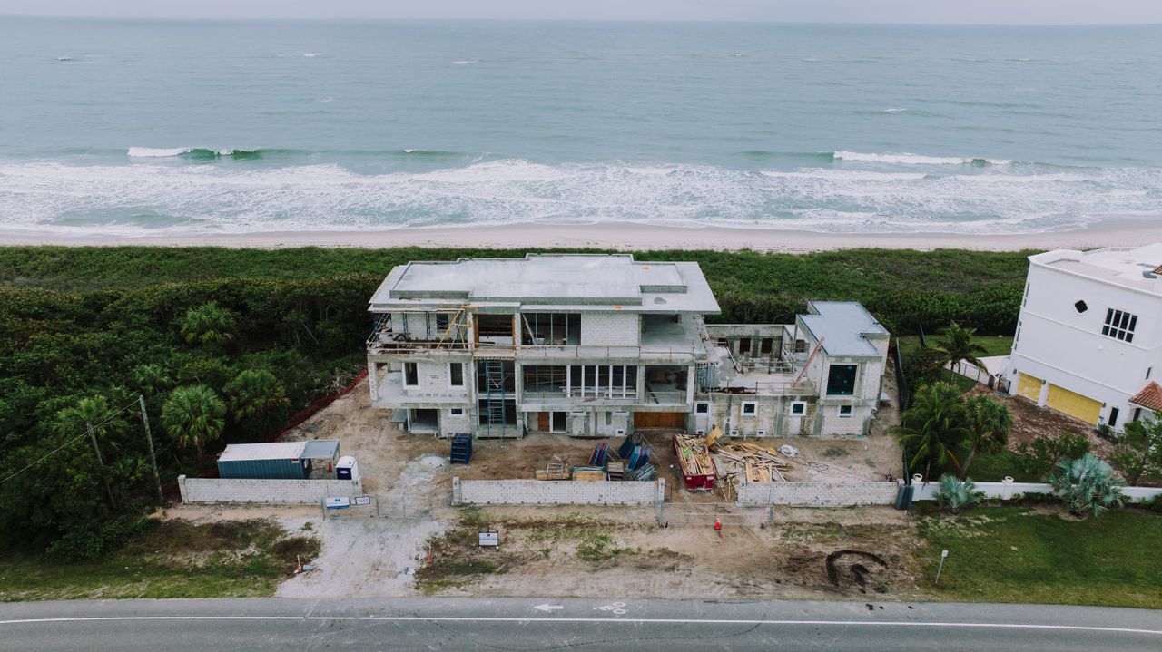 Florida coastal home under active construction showing concrete block building and scaffolding
