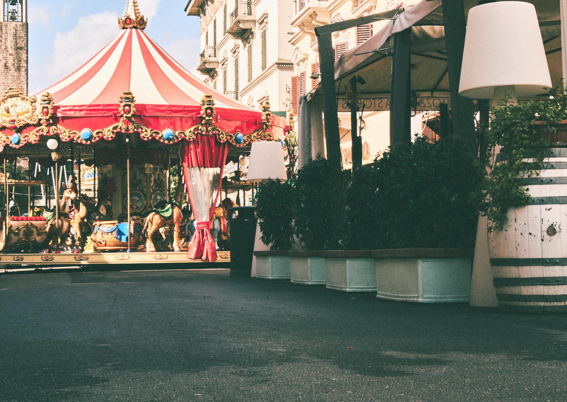 Elegant old-fashioned carousel in a vibrant Italian street, perfect for nostalgic travel imagery.