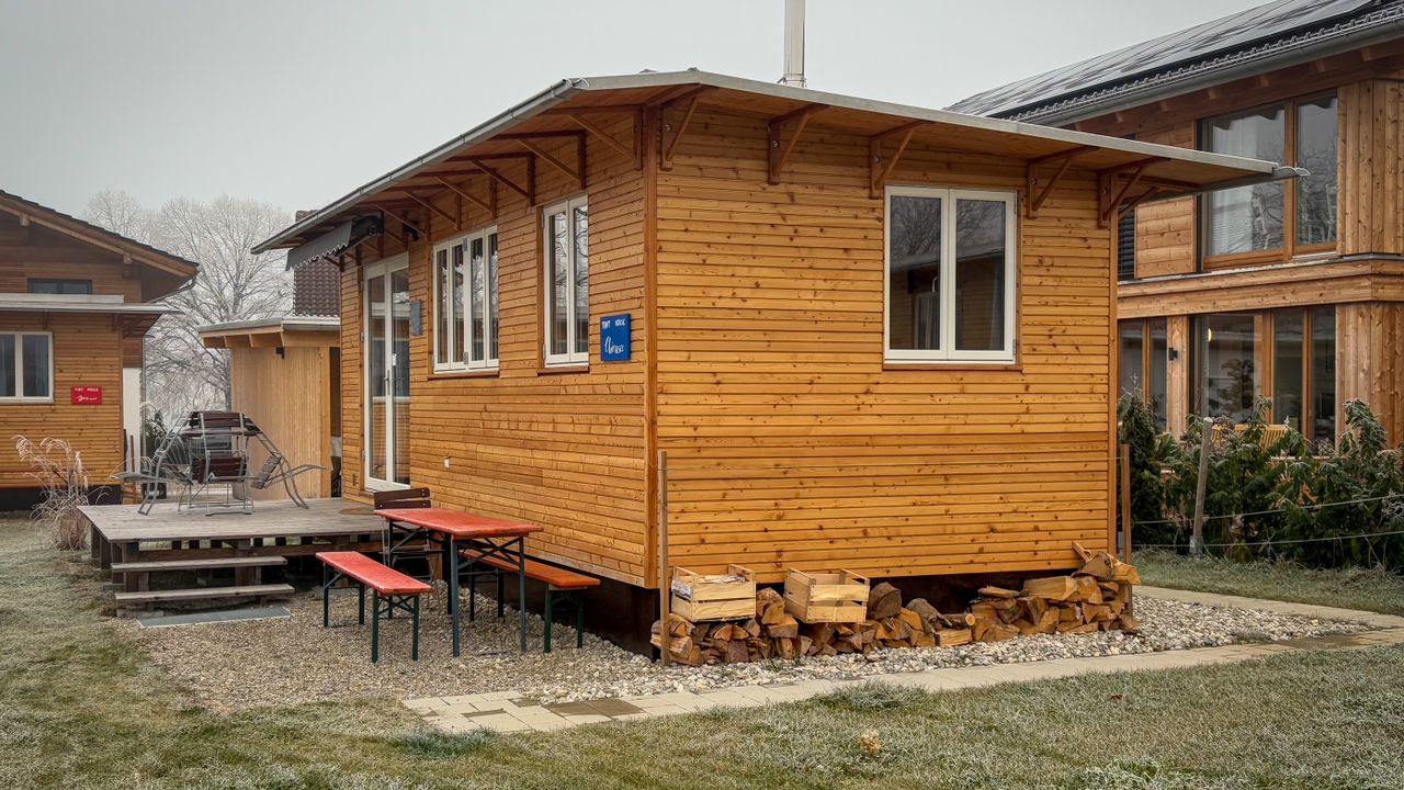 Small cabin as a compact housing option Small wooden cabin representing alternative compact housing options