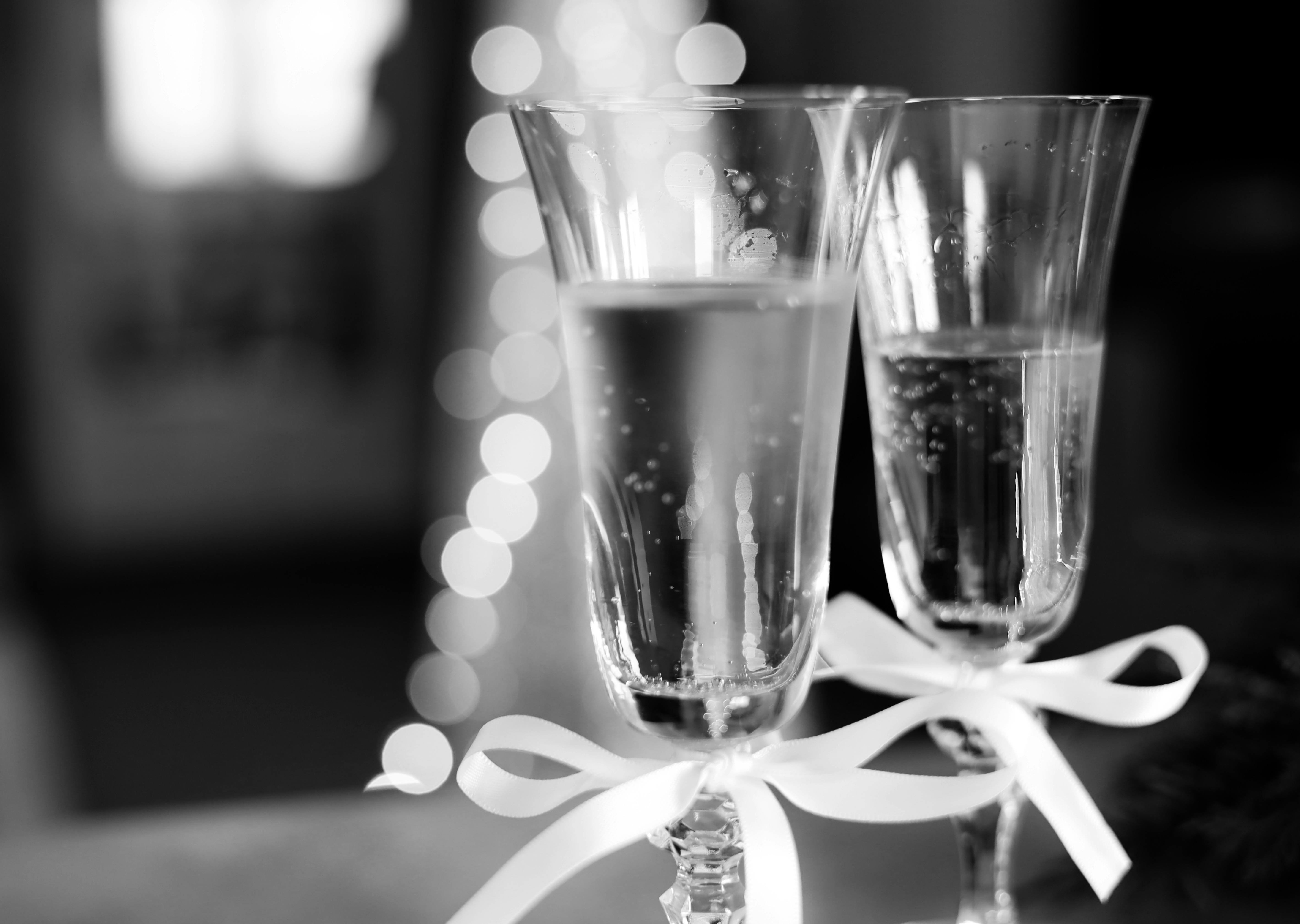 Two elegant champagne glasses with ribbons, ideal for celebrations