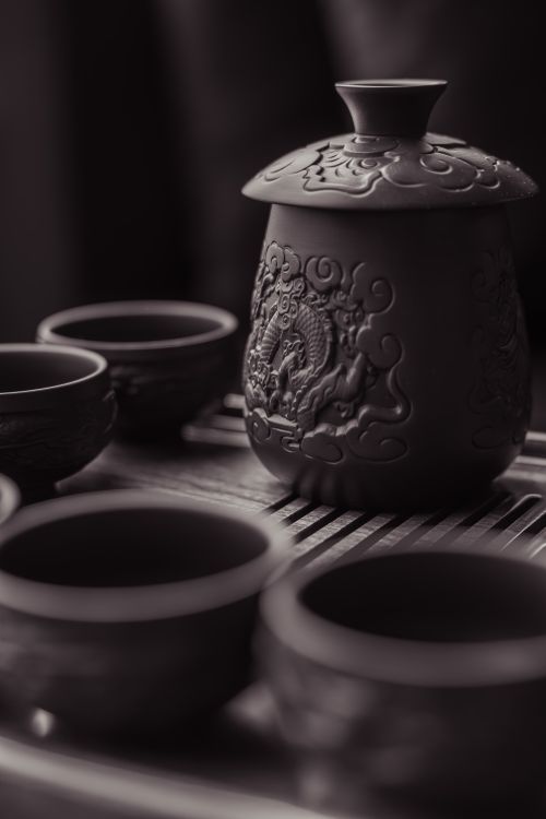 Free An artistic clay teapot and cups with intricate design, exuding classic elegance. Stock Photo
