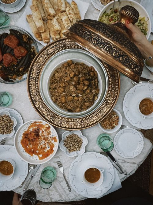 Free Exquisite Middle Eastern feast featuring diverse traditional dishes in elegant serving ware. Stock Photo