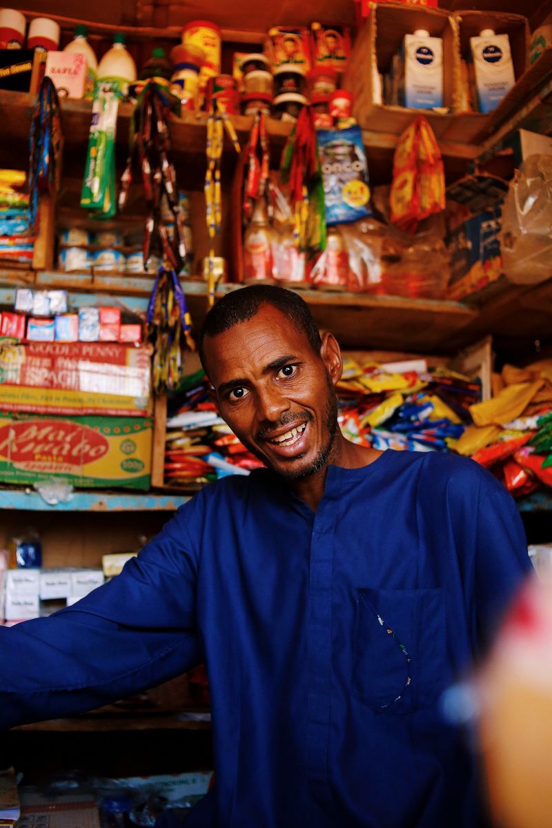 Shopkeeper organizing products in a local store