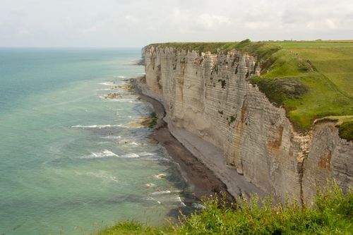 Free Stunning cliffs meeting the turquoise sea under a cloudy sky, epitomizing natural beauty. Stock Photo