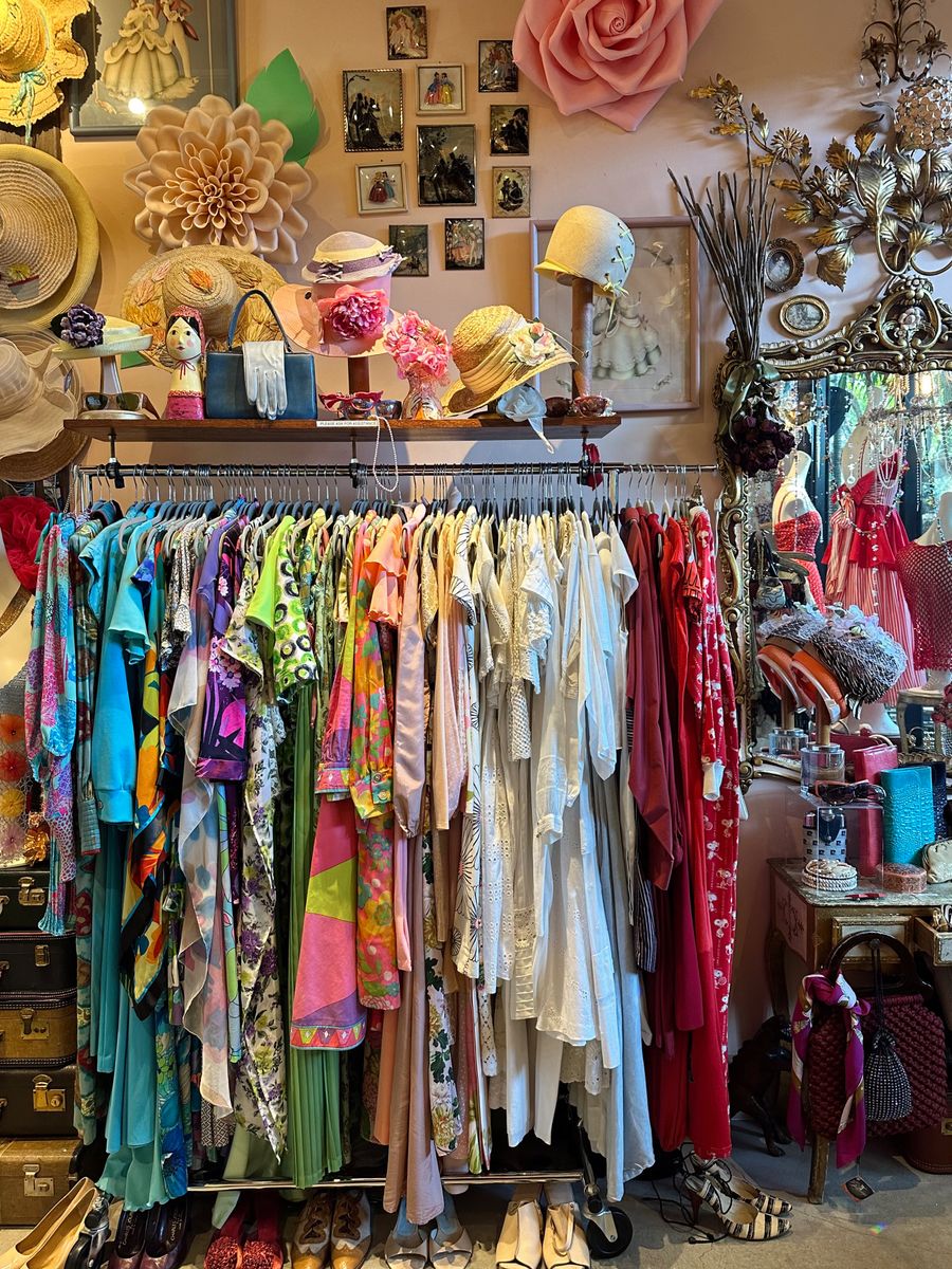 A rail of second-hand clothing in a small shop, photo by Sarah O'Shea on Pexels