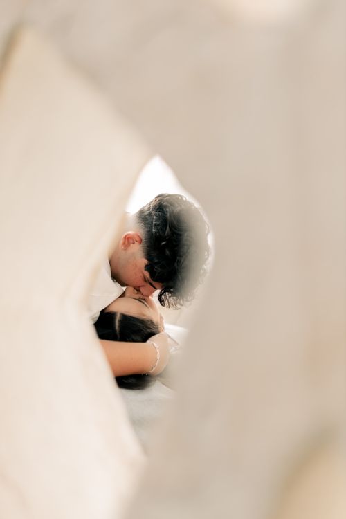 Free A young couple sharing a tender moment, captured through soft focus in a warm atmosphere. Stock Photo