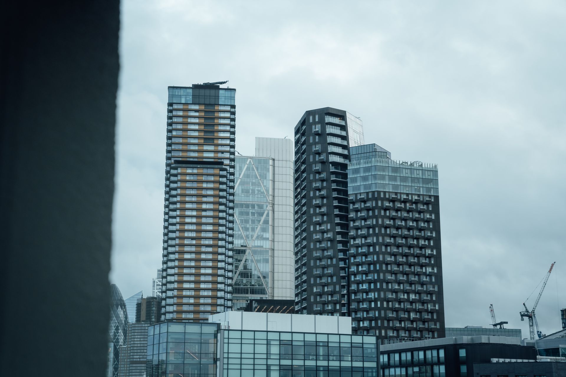 View of modern skyscrapers under cloudy sky in London, UK