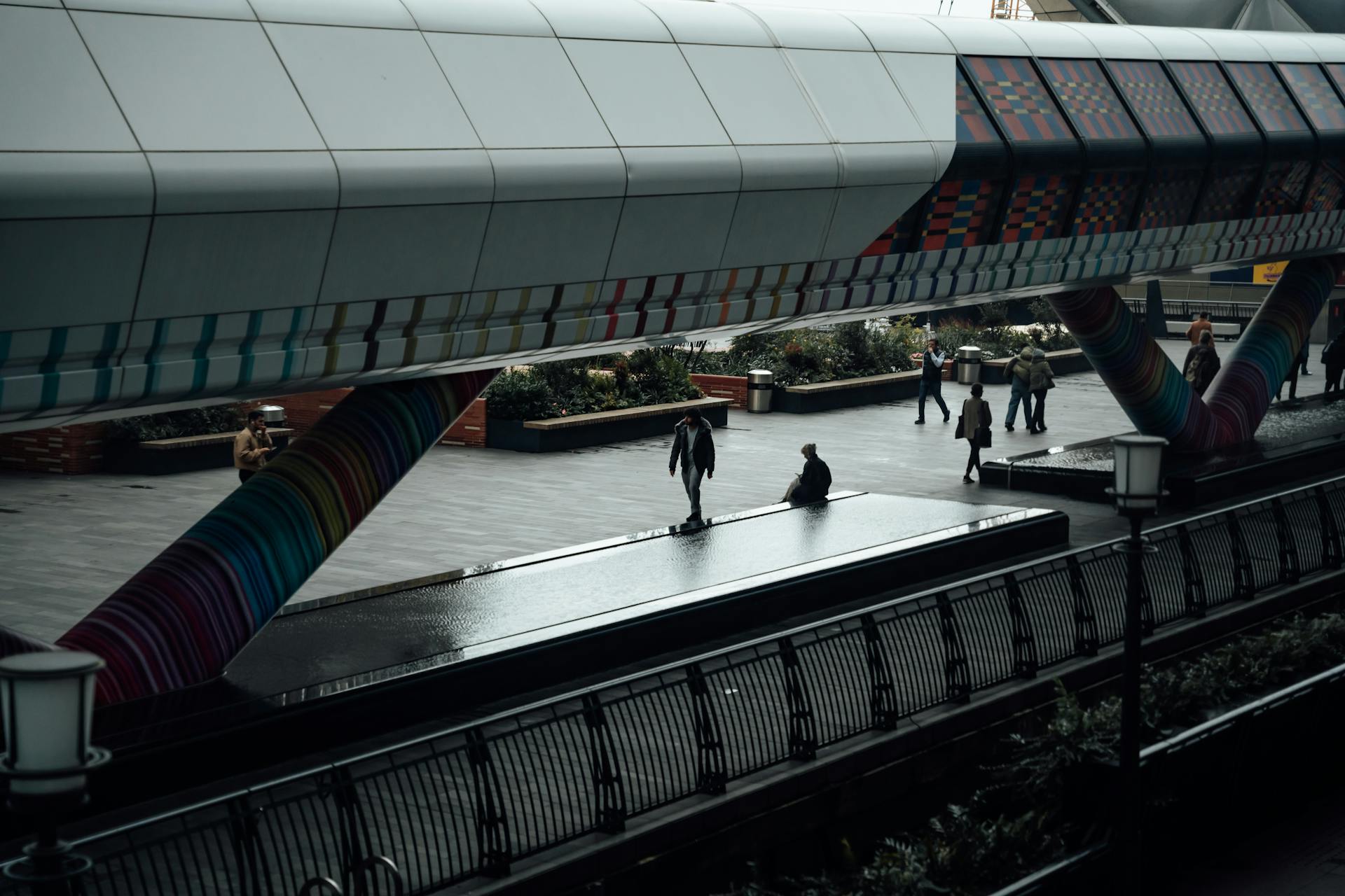 Vibrant bridge over a city walkway with people in London, England.