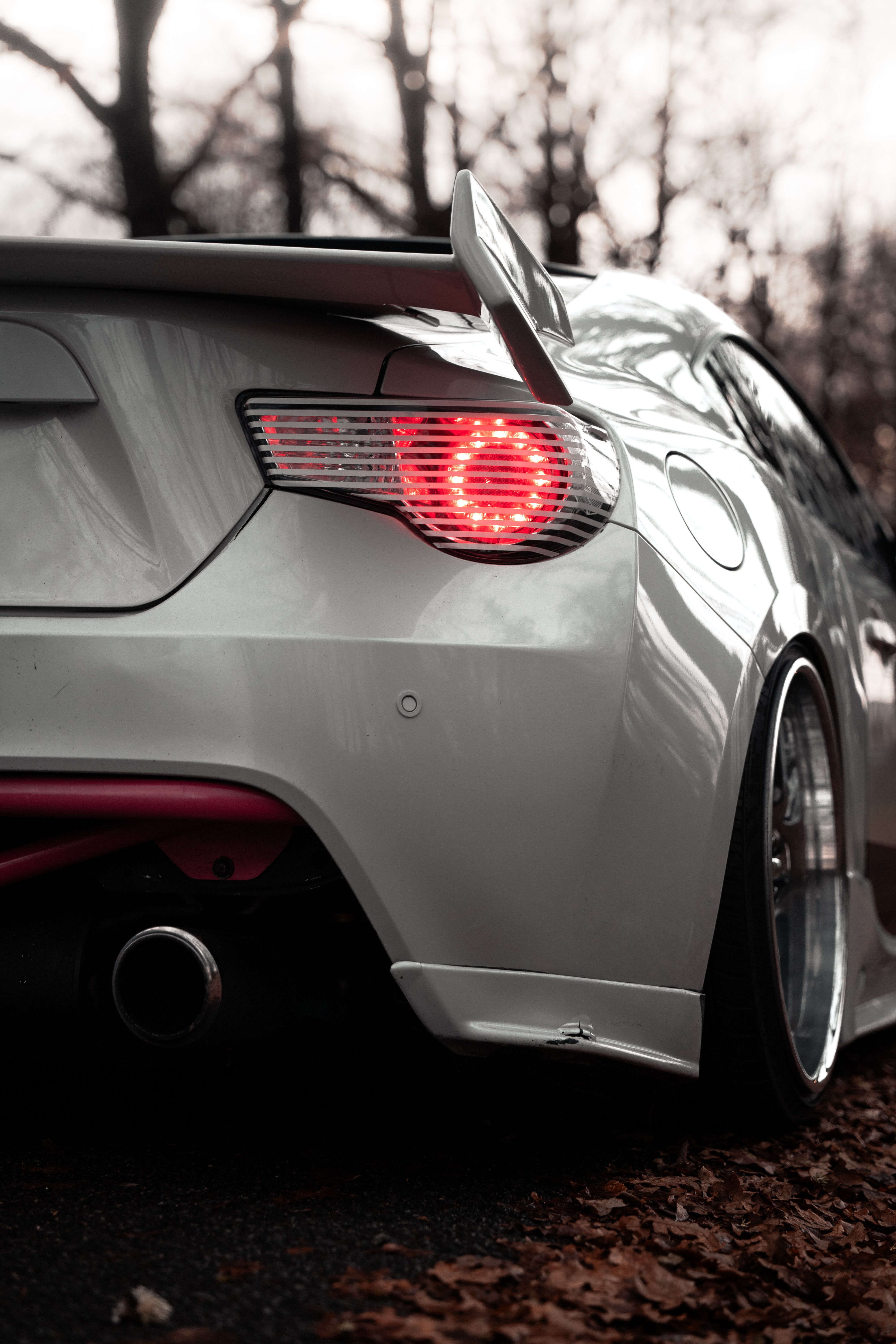 Rear view of stylish sports car in autumn scenery · Free Stock Photo