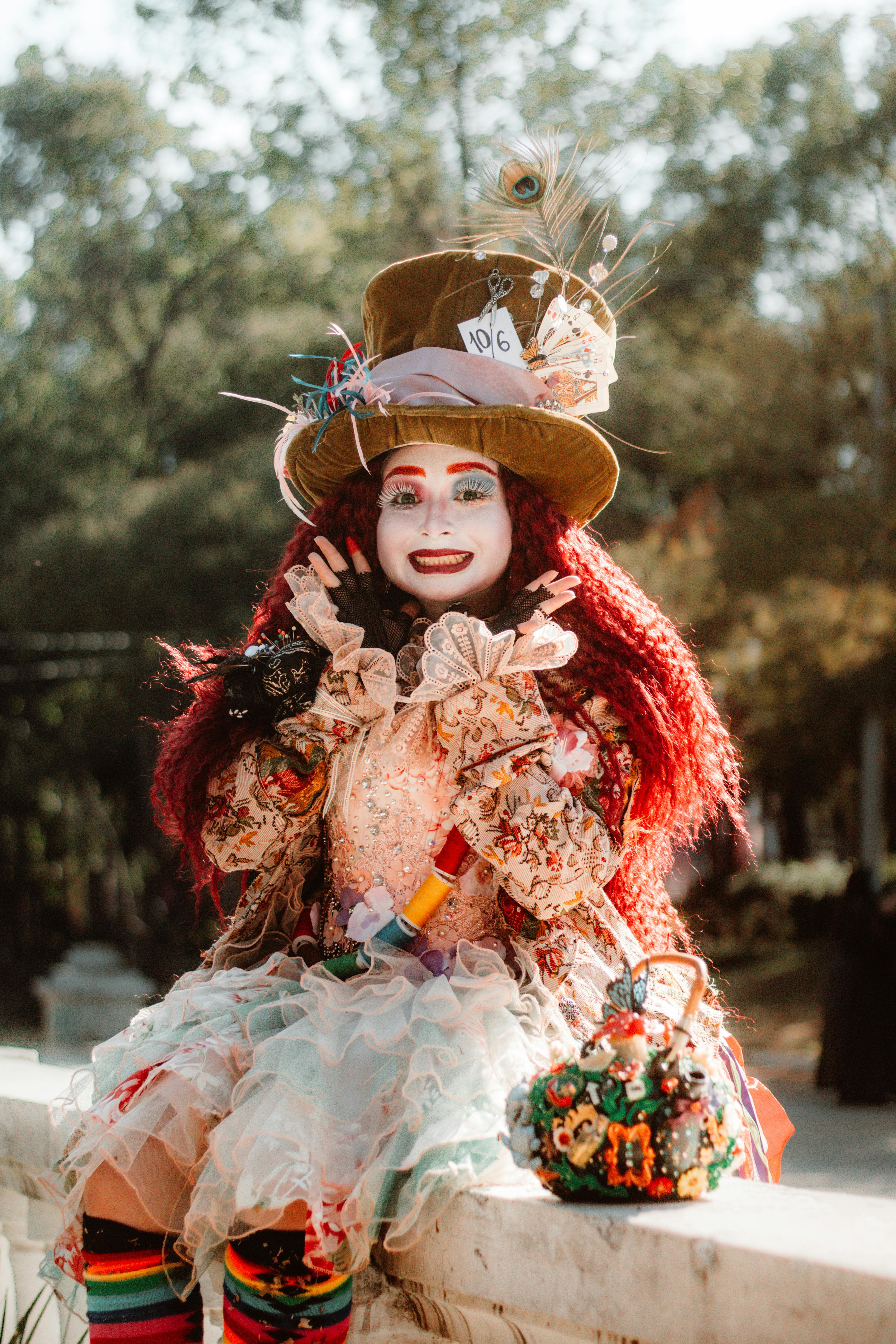 Free Vibrant Mad Hatter costume in whimsical park setting. Stock Photo