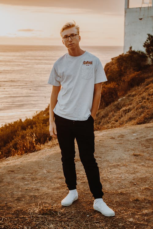 Photo of Man in White T-shirt and Black Jeans Posing