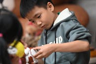 Young Boy Engaging with Toy in Casual Setting