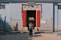 Man Praying Outside Traditional Asian Temple