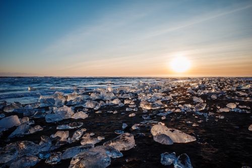 Free Stunning sunrise over shimmering ice blocks at Diamond Beach, Iceland, depicts nature's alluring beauty. Stock Photo