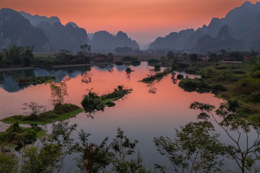 Breathtaking sunset over the serene lakes and limestone mountains of Lạng Sơn, Vietnam.