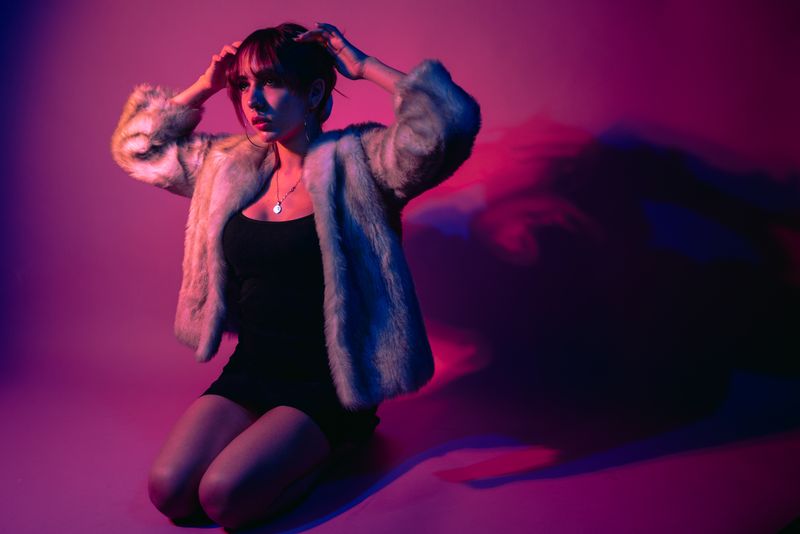 Woman in fur coat with dramatic lighting