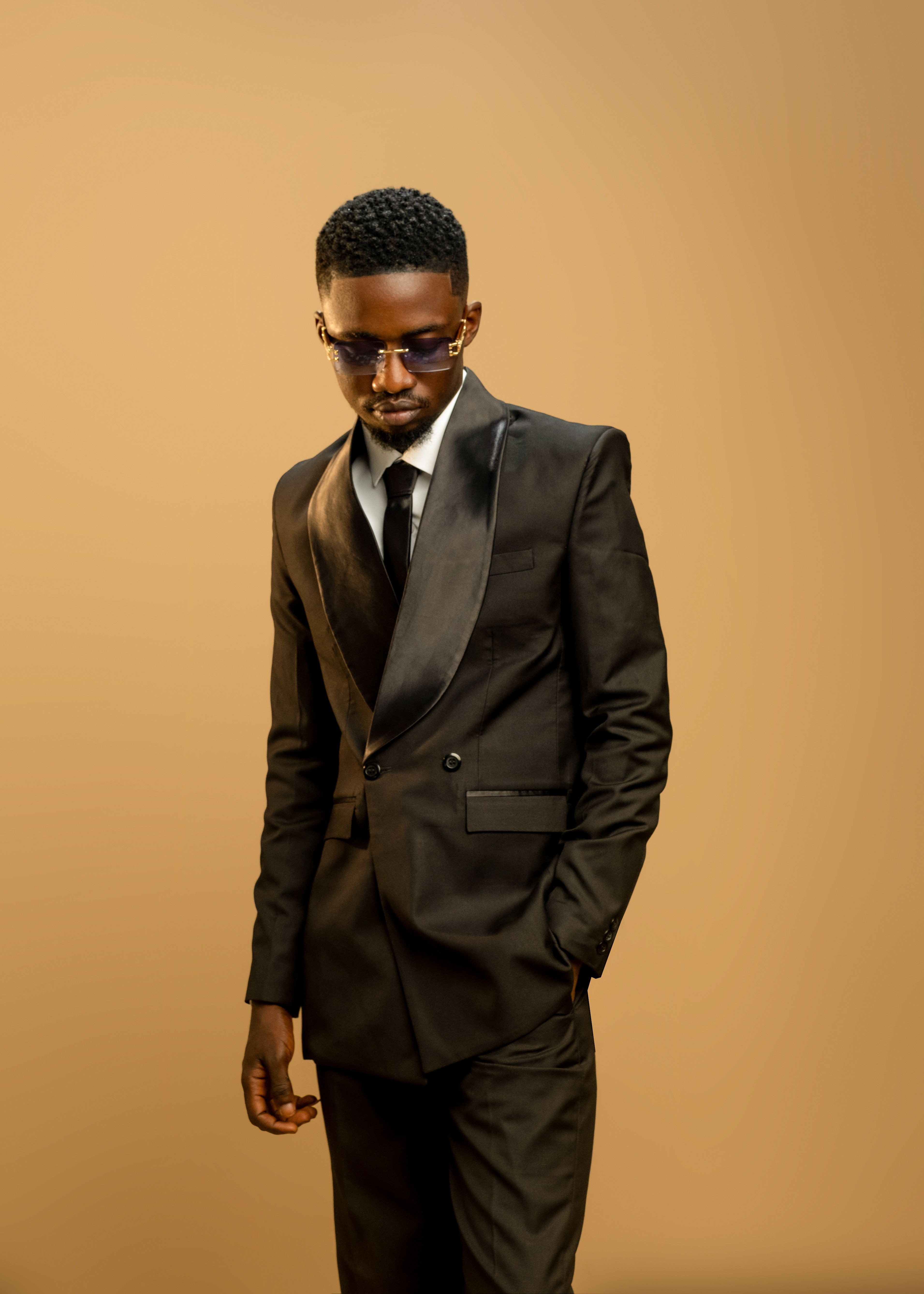 Stylish Young Man in Black Suit on Plain Background · Free Stock Photo