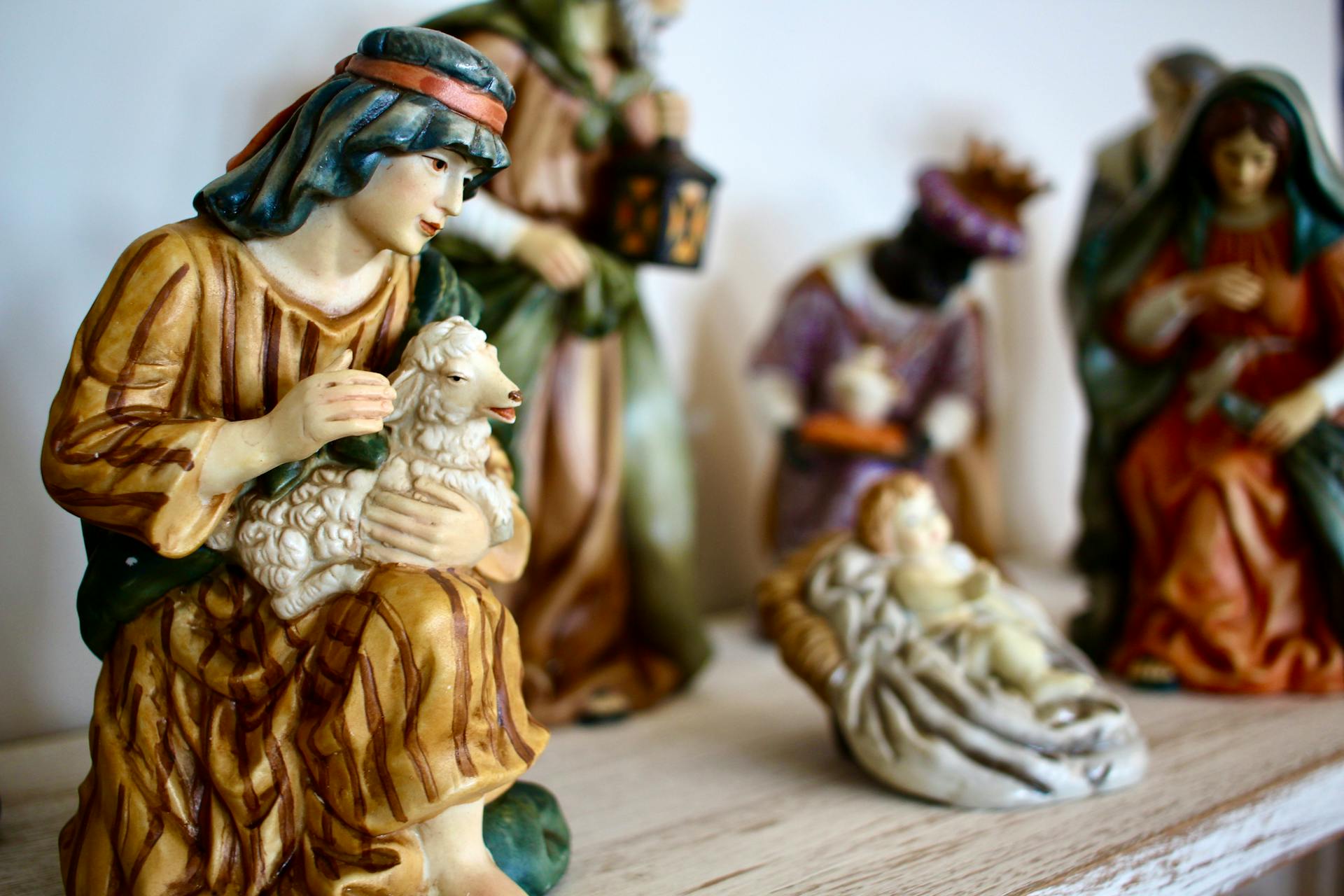 Intricate nativity scene figurines depicting the holy family and shepherds in a comforting display.