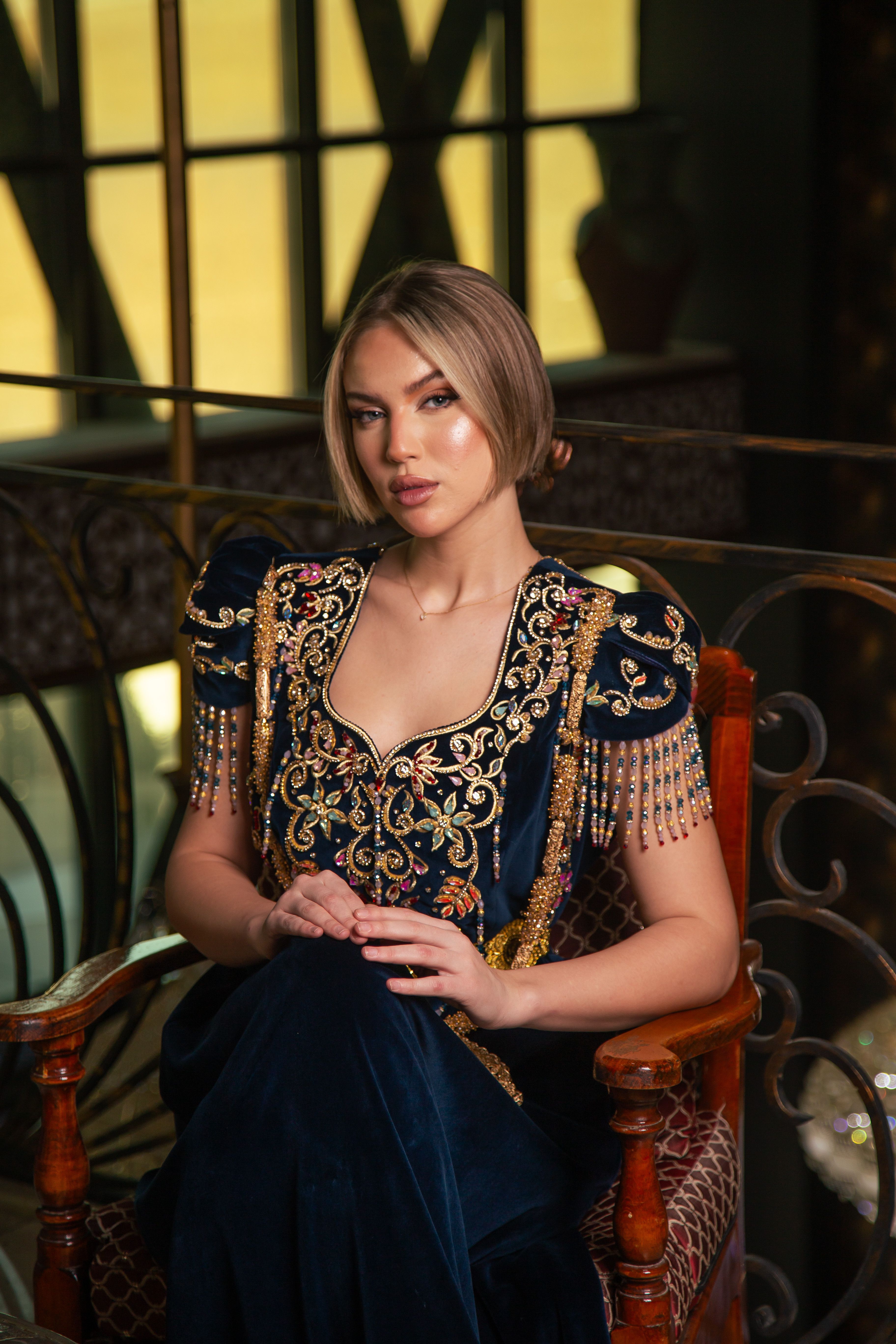 Stylish portrait of a woman in traditional Algerian attire, highlighting intricate embroidery.