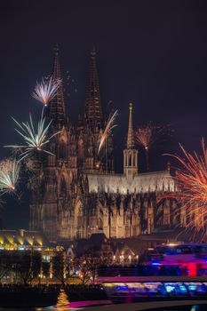 Magnificent view of Cologne Cathedral illuminated by vibrant fireworks, capturing a festive night in Germany.