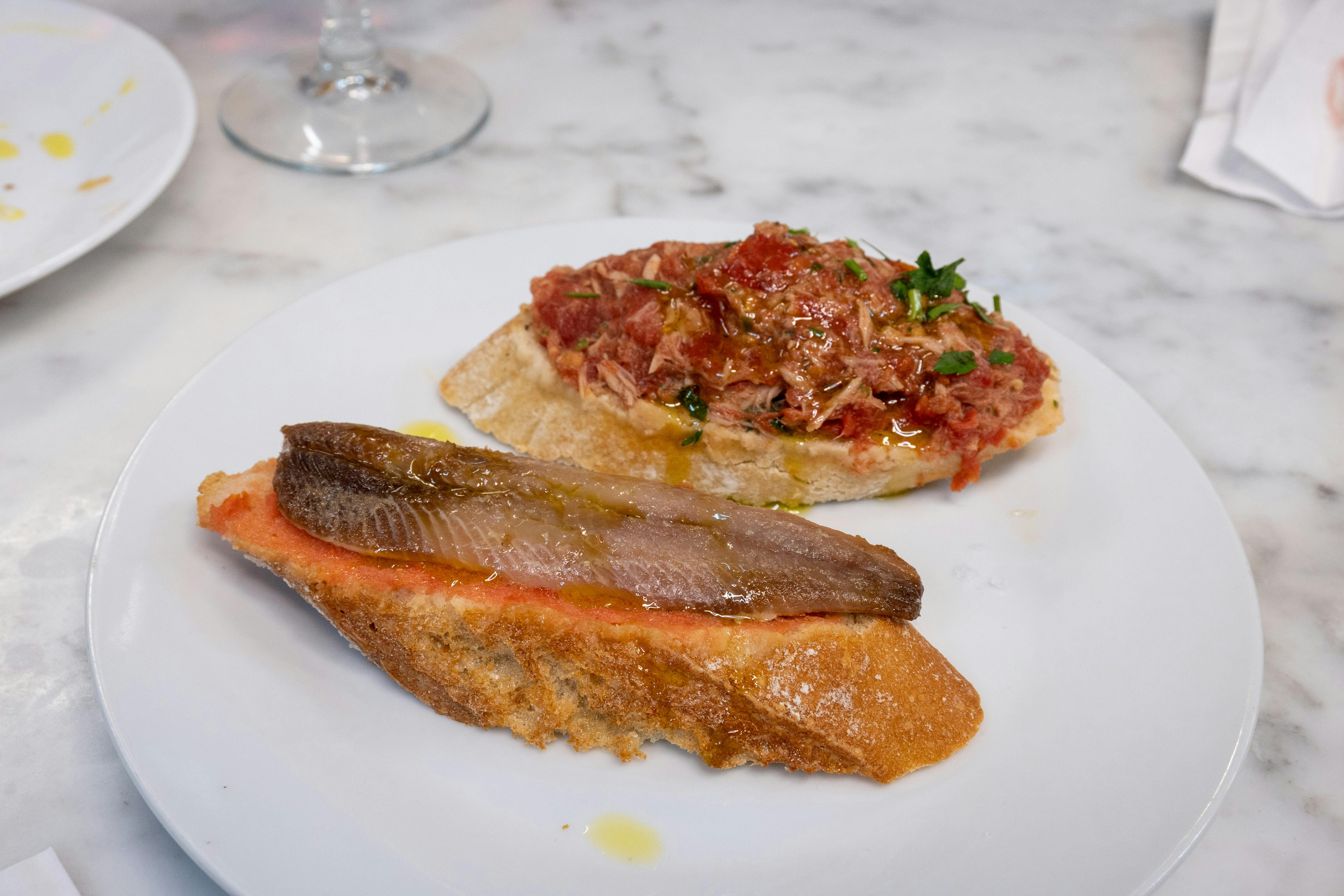 Free Savory Spanish tapas served on a white plate. Ideal for culinary content. Stock Photo