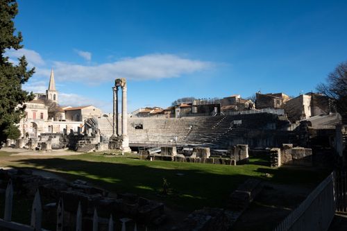 Free Historic Roman amphitheatre in Arles, France, showcasing ancient architecture under a bright sky. Stock Photo