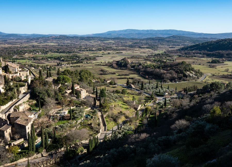 Aerial view of Gordes, a beautiful village in Provence, France with lush landscapes and historic architecture.