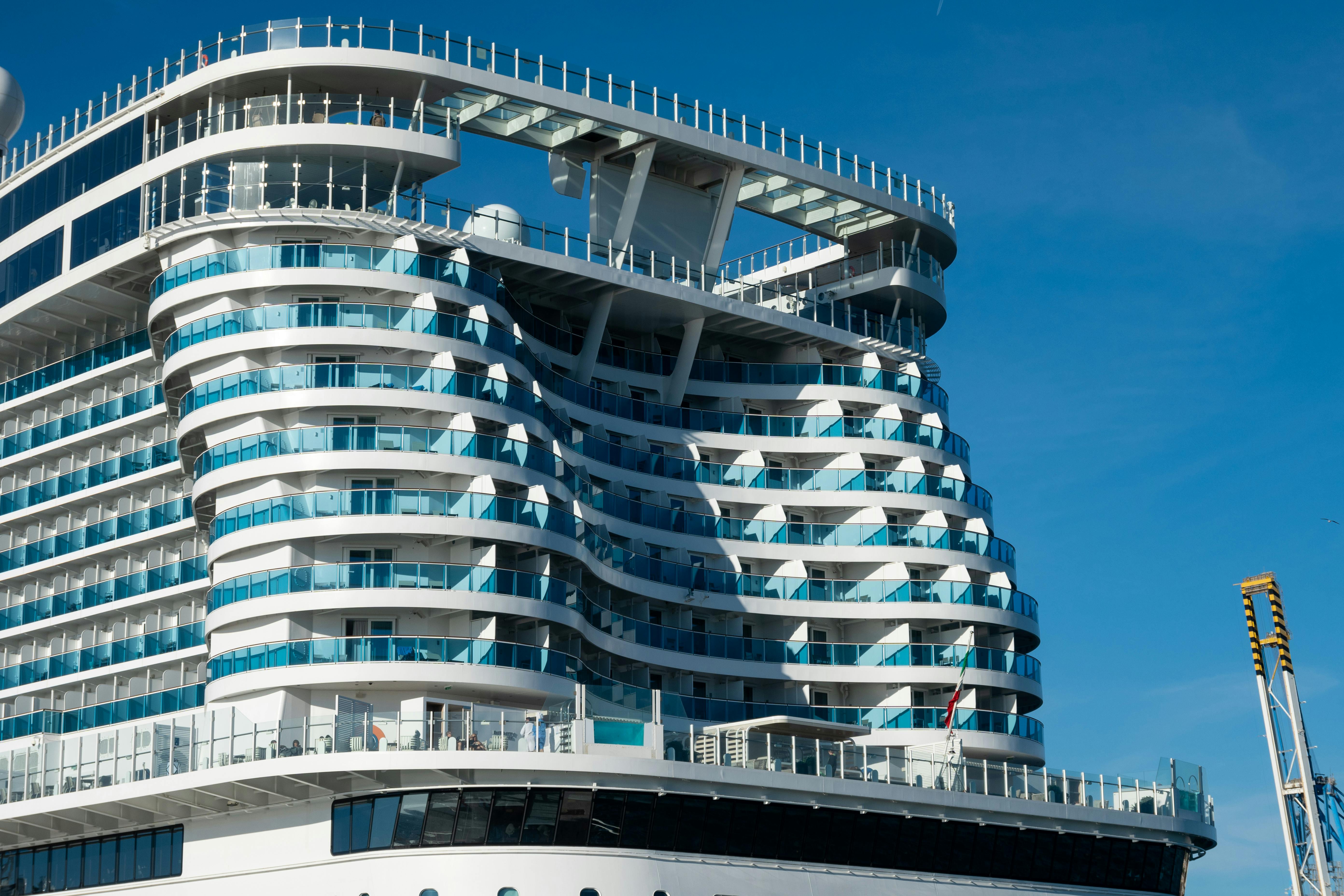 Close-up of a modern cruise ship's architecture with bright blue sky background.