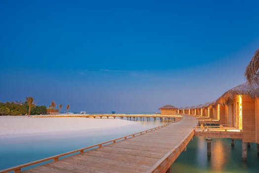 Serene overwater bungalows on a turquoise lagoon under a clear blue sky.