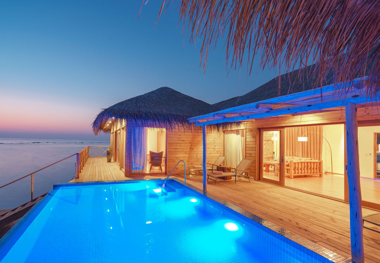 Overwater bungalow at sunset
